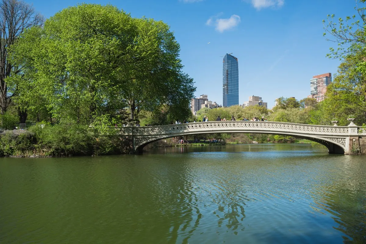 Bow Bridge and Central Park Lake with Central Park South skyline in the background.