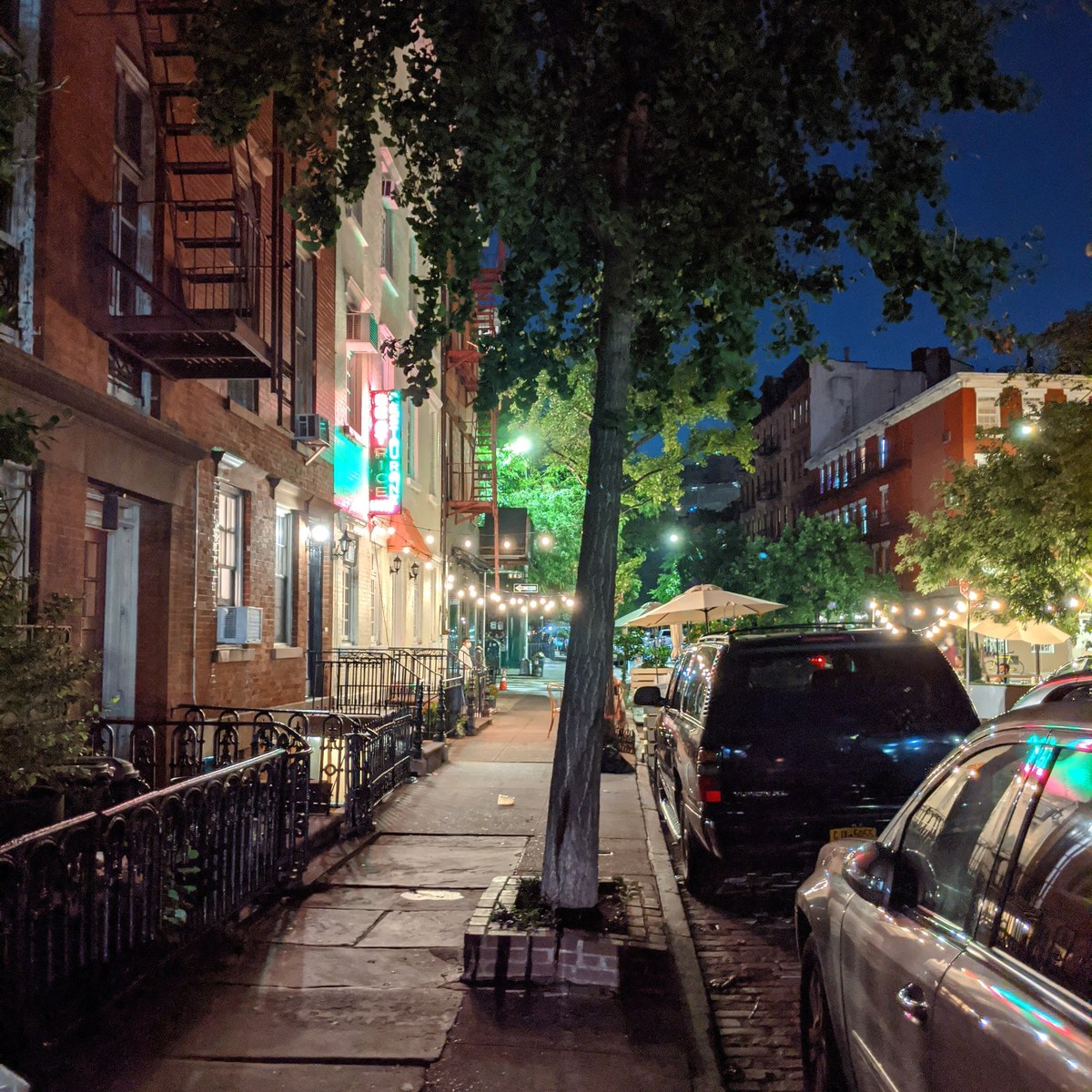 Evening streetscape with yellow NYC taxis and traffic in Greenwich Village Manhattan
