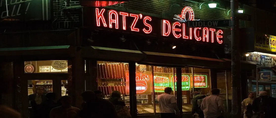 Hand-carved hot pastrami on rye sandwich at Katzās Delicatessen under bright late-night neon lighting