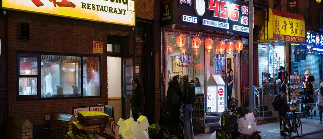 Subterranean entrance and bustling interior of Wo Hop at 17 Mott Street Chinatown Manhattan
