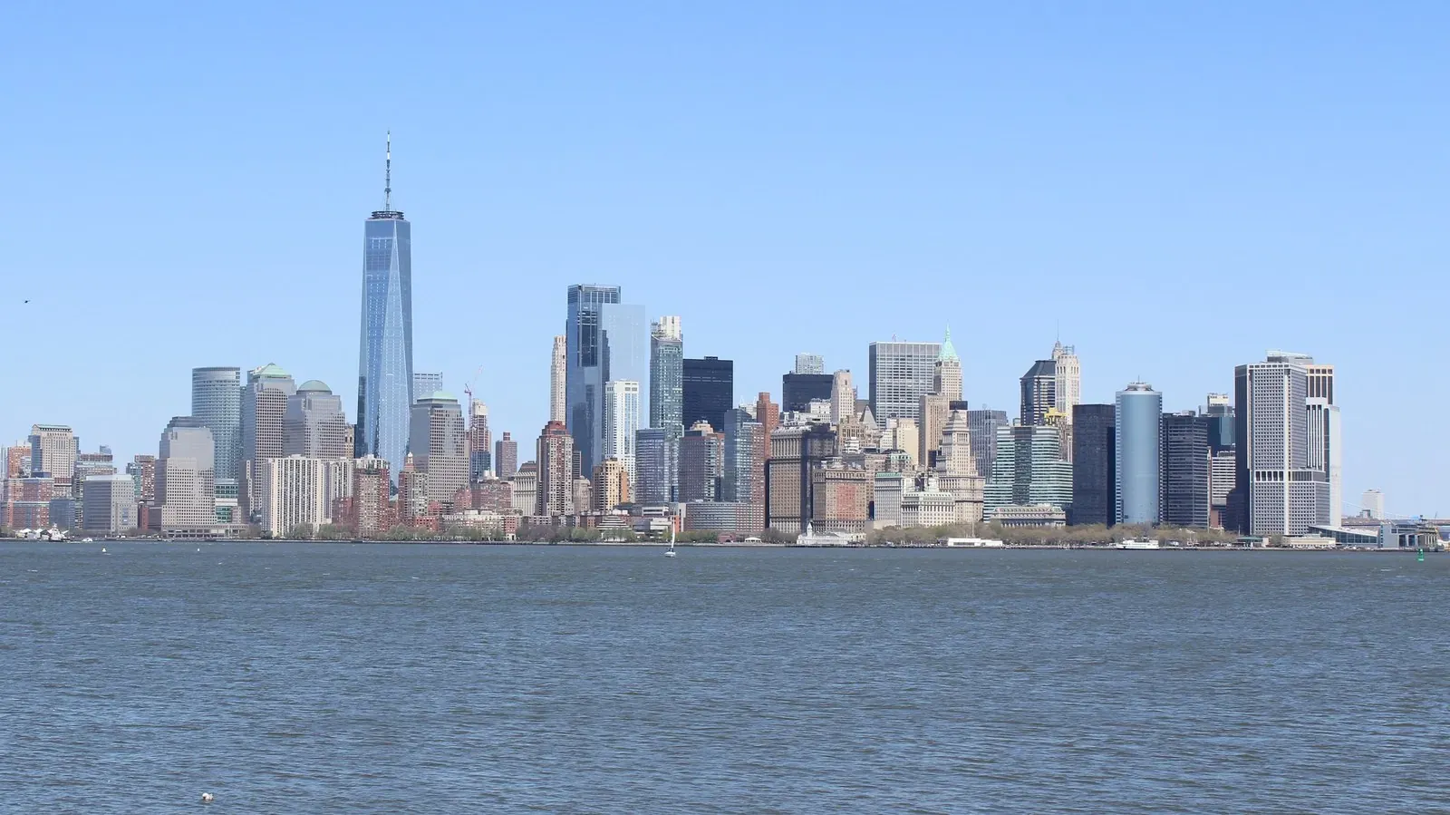 Lower Manhattan skyline and harbor seen from the downtown waterfront on a clear day