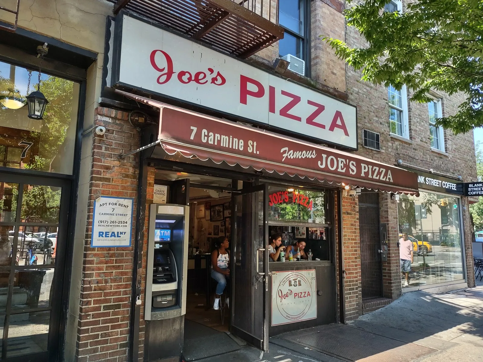 Iconic Joe's Pizza storefront and classic slice counter in Greenwich Village, Manhattan.