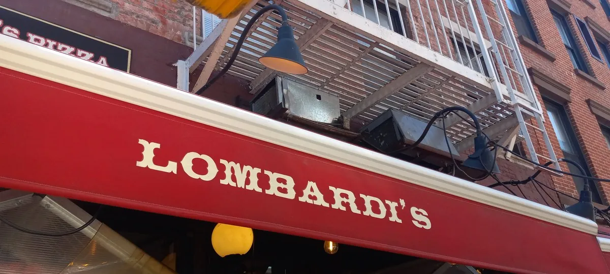 Historic Lombardi’s Pizza exterior on Spring Street in Little Italy