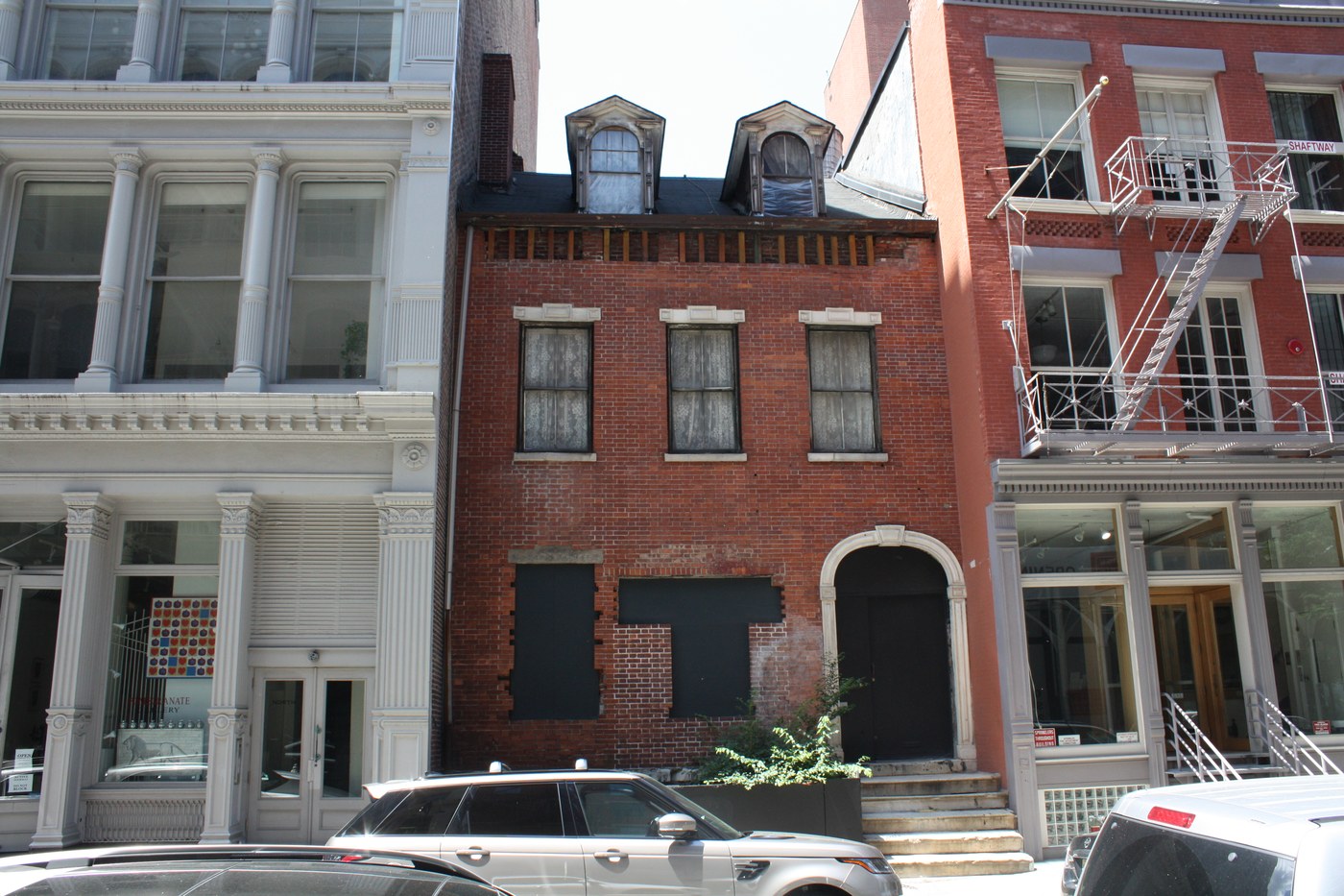 Detailed cast-iron columns and iconic fire escape balconies on Greene Street, SoHo