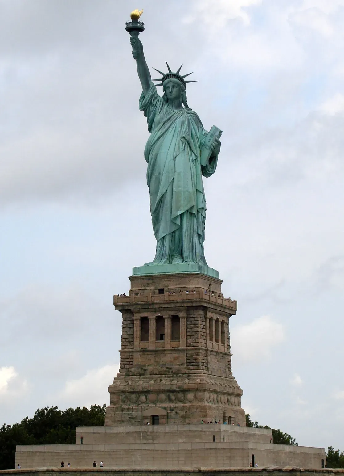 Statue of Liberty seen from the harbor with Lower Manhattan skyline behind