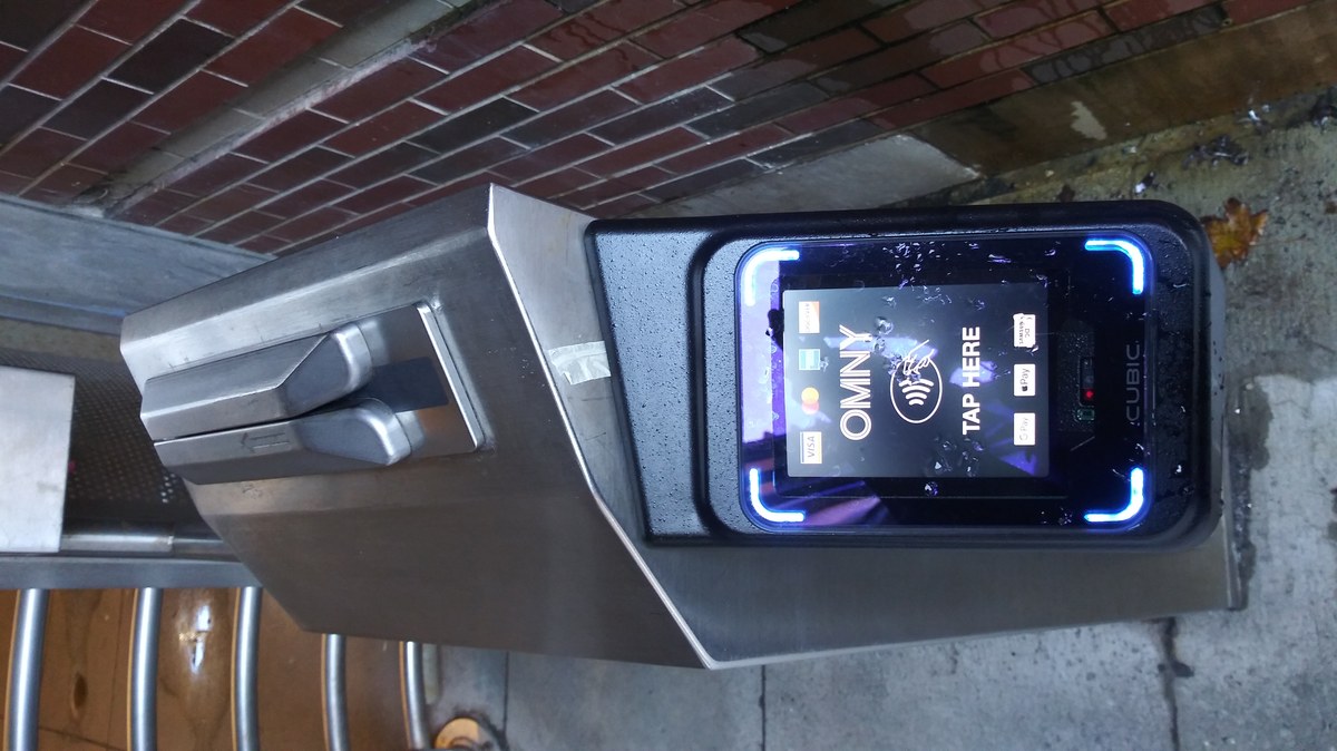 OMNY contactless fare tap gate at NYC subway and airport transit connection turnstiles