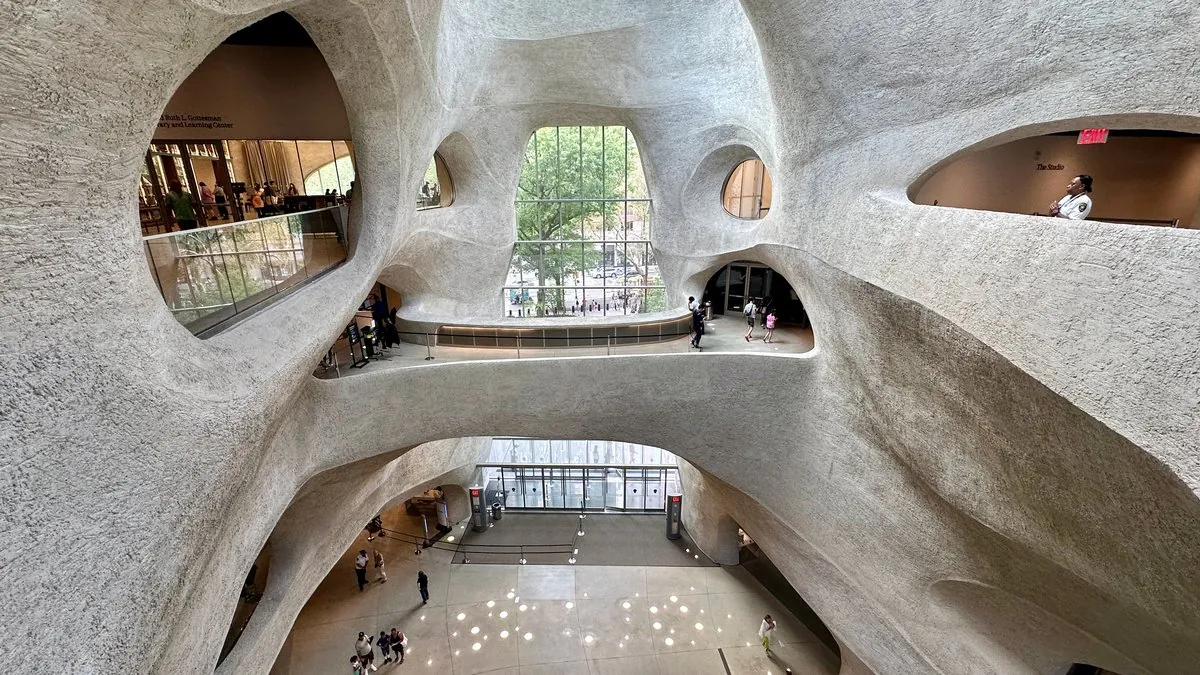 Curved white concrete atrium interior of the Richard Gilder Center at AMNH