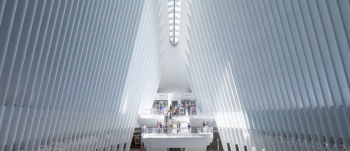 The Oculus interior concourse at World Trade Center with white architectural ribs and commuters